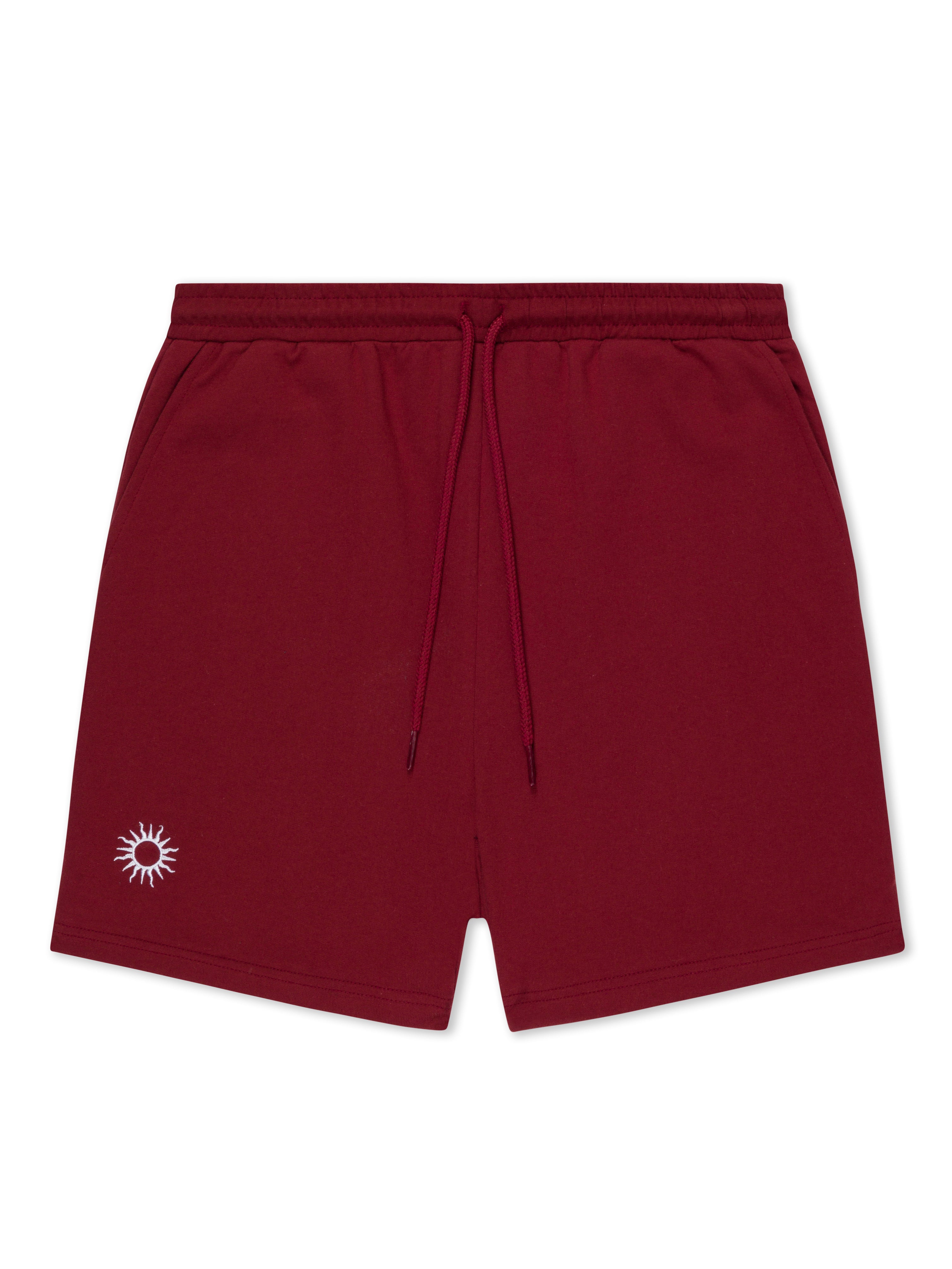red cotton training shorts with white sun embroidered on left leg