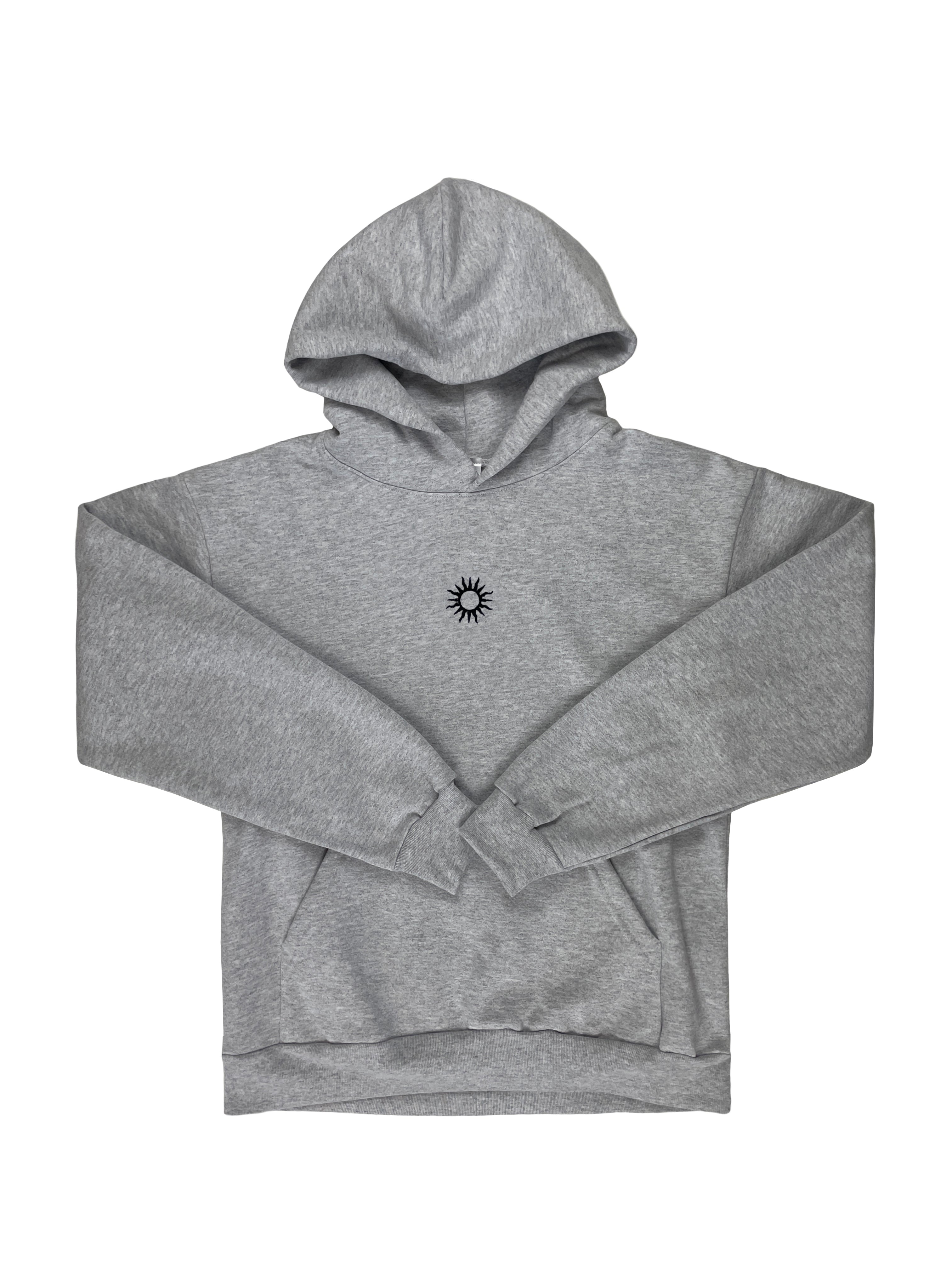grey 100% cotton hoodie with a black embroidered sun in the centre of the chest