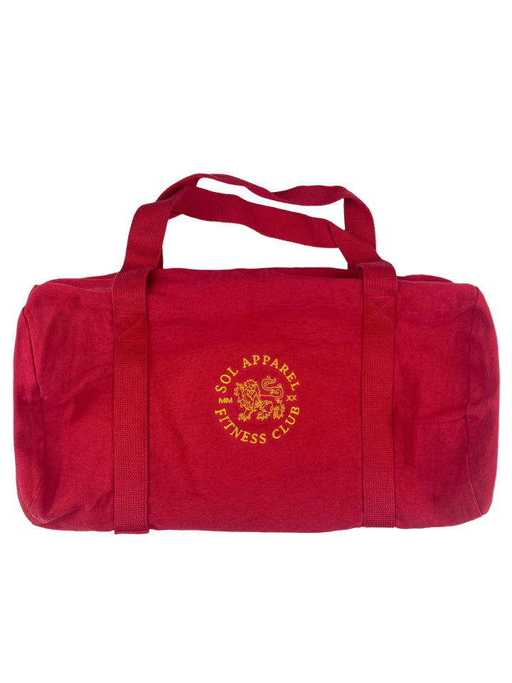 red cotton gym duffel bag with golden embroidered logo of a lion and the text sol apparel fitness club