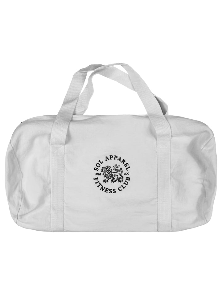 white gym duffel bag in cotton with black embroidered logo of a lion and the text sol apparel fitness club
